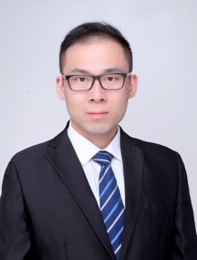 A person wearing glasses and a suitDescription automatically generated with medium confidence